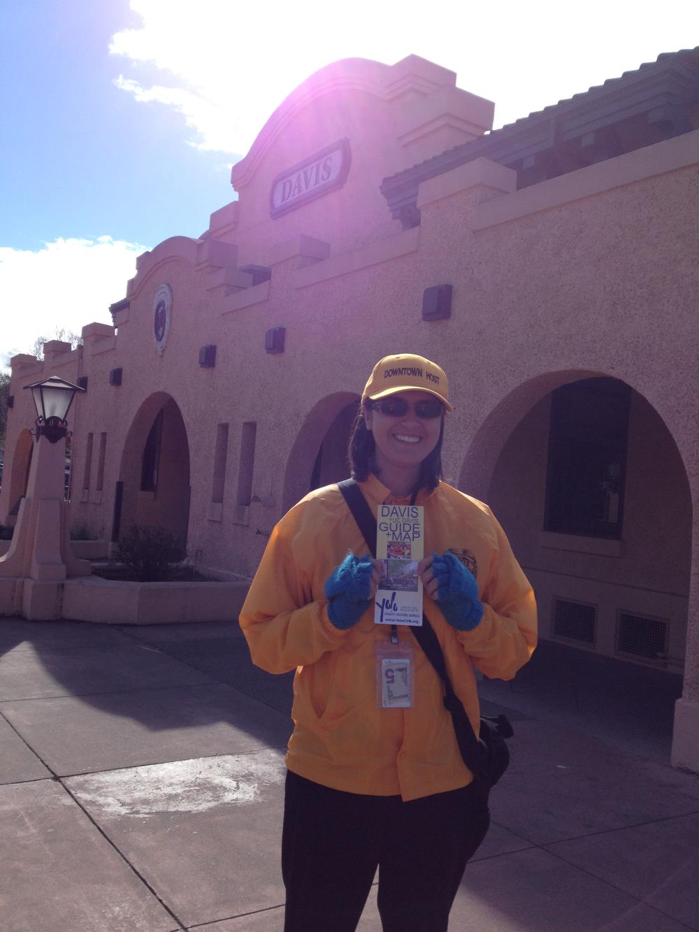 smiling female volunteer in a yellow sweater